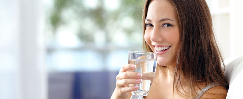 happy woman drinking a glass of water
