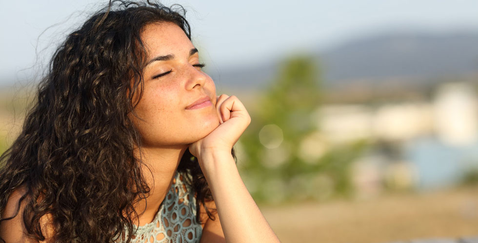 smiling brunette woman in the sun